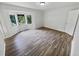 Large bedroom with bay window and wood-look vinyl flooring at 5351 Zachary Dr, Stone Mountain, GA 30083