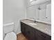 Bathroom features granite countertop, dark brown vanity, and updated flooring at 5351 Zachary Dr, Stone Mountain, GA 30083