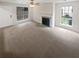 Living room with fireplace, neutral carpeting and multiple windows at 1097 Rock Creek Ln, Norcross, GA 30093