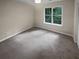 Bright bedroom with grey carpet and large window at 1097 Rock Creek Ln, Norcross, GA 30093