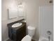 Bathroom with tub, toilet and dark vanity at 1097 Rock Creek Ln, Norcross, GA 30093
