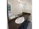 Main bathroom with dark vanity, double sinks and vinyl flooring at 1097 Rock Creek Ln, Norcross, GA 30093