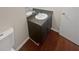 Bathroom with dark vanity, single sink and vinyl flooring at 1097 Rock Creek Ln, Norcross, GA 30093