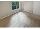Bright bedroom with neutral carpet and large window at 1097 Rock Creek Ln, Norcross, GA 30093