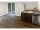 Eat-in kitchen with sliding glass doors to backyard and dark cabinetry at 1097 Rock Creek Ln, Norcross, GA 30093