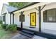 Eye-catching yellow front door with black accents at 10100 Clearview Nw Dr, Covington, GA 30014