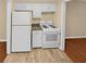 Efficient kitchen with white appliances and granite countertops at 309 Quail Run, Roswell, GA 30076