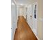 Long hallway with wood flooring and neutral walls at 309 Quail Run, Roswell, GA 30076