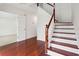 Well-lit staircase with hardwood floors and a classic wooden railing at 1760 Waterton Ln, Lithonia, GA 30058