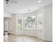 Spacious living room featuring bay windows and light hardwood floors at 1760 Waterton Ln, Lithonia, GA 30058