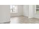 Simple bedroom with light gray laminate wood flooring and neutral-colored walls at 1760 Waterton Ln, Lithonia, GA 30058