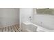Clean bathroom with a large bathtub and black and white checkered floor at 1760 Waterton Ln, Lithonia, GA 30058