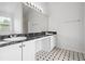 Bathroom with double vanity, granite countertop, and black and white tile floor at 1760 Waterton Ln, Lithonia, GA 30058