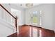 Bright entryway with hardwood floors, elegant chandelier, and a view of the staircase at 1760 Waterton Ln, Lithonia, GA 30058