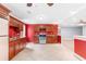 Red walls and wood cabinets in this galley kitchen at 3850 Shady Grove Rd, Carrollton, GA 30116