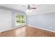 Bedroom with hardwood floors, large window and ceiling fan at 3850 Shady Grove Rd, Carrollton, GA 30116