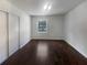Empty bedroom with dark hardwood floors and a window at 4128 Snapfinger Way, Decatur, GA 30035