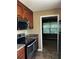Updated kitchen with stainless steel appliances and dark wood cabinets at 9184 S Sterling Lakes S Dr, Covington, GA 30014