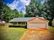 Ranch style home with mature trees and a paved driveway at 9184 S Sterling Lakes S Dr, Covington, GA 30014