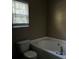 Clean bathroom with a bathtub and window at 9184 S Sterling Lakes S Dr, Covington, GA 30014