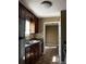 Kitchen with dark wood cabinets and view of dining area at 9184 S Sterling Lakes S Dr, Covington, GA 30014