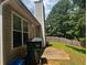 Side view of a house with vinyl siding, a large tree, and a patio at 9184 S Sterling Lakes S Dr, Covington, GA 30014