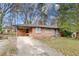 Brick ranch house with attached carport and landscaped yard at 4928 Glaze Dr, Atlanta, GA 30360