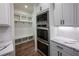 Butlers pantry with built-in shelving and a bench at 1147 Red Oak Blvd, Loganville, GA 30052