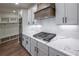 Modern kitchen with white cabinets, gas range, and quartz countertops at 1147 Red Oak Blvd, Loganville, GA 30052
