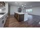 Open concept kitchen with island, fireplace and hardwood floors at 1147 Red Oak Blvd, Loganville, GA 30052