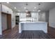 Modern kitchen featuring white cabinets, quartz countertops, and a large island at 1147 Red Oak Blvd, Loganville, GA 30052