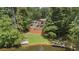 Luxury home with pool and pond, surrounded by lush greenery at 2341 Habersham Sw Dr, Marietta, GA 30064