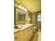 Spa-like bathroom with granite vanity, tufted wallpaper, and large mirror at 2341 Habersham Sw Dr, Marietta, GA 30064