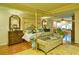 Luxurious main bedroom with a gold canopy bed and sitting area at 2341 Habersham Sw Dr, Marietta, GA 30064