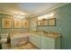 Bathroom boasts a soaking tub, granite vanity, and decorative mirrors at 2341 Habersham Sw Dr, Marietta, GA 30064