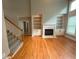 Spacious living room with hardwood floors, fireplace, built-in shelving, and high ceilings at 617 Vinings Estates Se Dr, Mableton, GA 30126