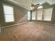 Large bedroom with ceiling fan, neutral carpeting, and multiple windows at 617 Vinings Estates Se Dr, Mableton, GA 30126