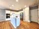 Bright kitchen boasts white cabinets, stainless steel appliances, and hardwood floors at 617 Vinings Estates Se Dr, Mableton, GA 30126