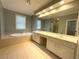 Primary bathroom with double vanity, soaking tub, and tile flooring at 617 Vinings Estates Se Dr, Mableton, GA 30126