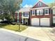 Brick two-story home with two-car garage, balcony, and landscaping at 617 Vinings Estates Se Dr, Mableton, GA 30126