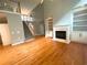 Two-story living room with hardwood floors, fireplace, built-in shelving, and high ceilings at 617 Vinings Estates Se Dr, Mableton, GA 30126