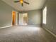 Bright bedroom featuring carpet, ceiling fan and access to bathroom and hallway at 617 Vinings Estates Se Dr, Mableton, GA 30126