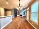 Open dining area with hardwood floors, high ceilings, and access to the kitchen at 617 Vinings Estates Se Dr, Mableton, GA 30126