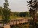 Wooden boardwalk winding through a lush green landscape; provides scenic walking path at 626 Skytop Dr # 159, Cumming, GA 30040