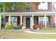 Brick home with a covered porch and landscaping at 3824 Smith Creek Ct, Buford, GA 30519