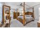 Elegant bedroom with a large four-poster bed and ample space at 2444 Ballantrae Cir, Cumming, GA 30041