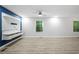 Living area with hardwood floors, ceiling fan and large windows at 1151 2Nd Nw St, Atlanta, GA 30318