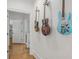 Bright hallway with hardwood floors and guitars on the wall at 1831 Highway 92, Fayetteville, GA 30215