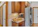 Kitchen nook with granite countertops and wood cabinetry at 1831 Highway 92, Fayetteville, GA 30215