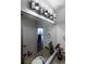 Modern bathroom with granite countertop, large mirror, and city view at 400 W Peachtree Nw St # 2314, Atlanta, GA 30308